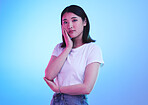 Fashion, neon and portrait of Asian woman in studio for style, promotion and branding on blue background. Creative lighting, advertising and isolated person in trendy, casual and clothes for beauty