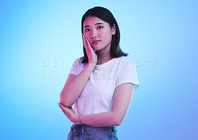 Buy stock photo Fashion, neon and portrait of Asian woman in studio for style, promotion and retail sale on blue background. Creative lighting, beauty and isolated Japanese person in trendy, casual and cool clothes