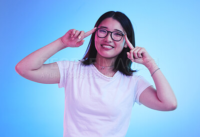 Buy stock photo Portrait, thinking and Asian woman with glasses, ideas and opportunity on a blue studio background. Japanese person, face and model with eyewear, solution and decision with problem solving and choice