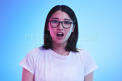 Buy stock photo Surprise, portrait and face of Asian woman with wow expression or open mouth for drama, deal and promotion. Omg, wtf and portrait of person with discount emoji isolated in a studio blue background