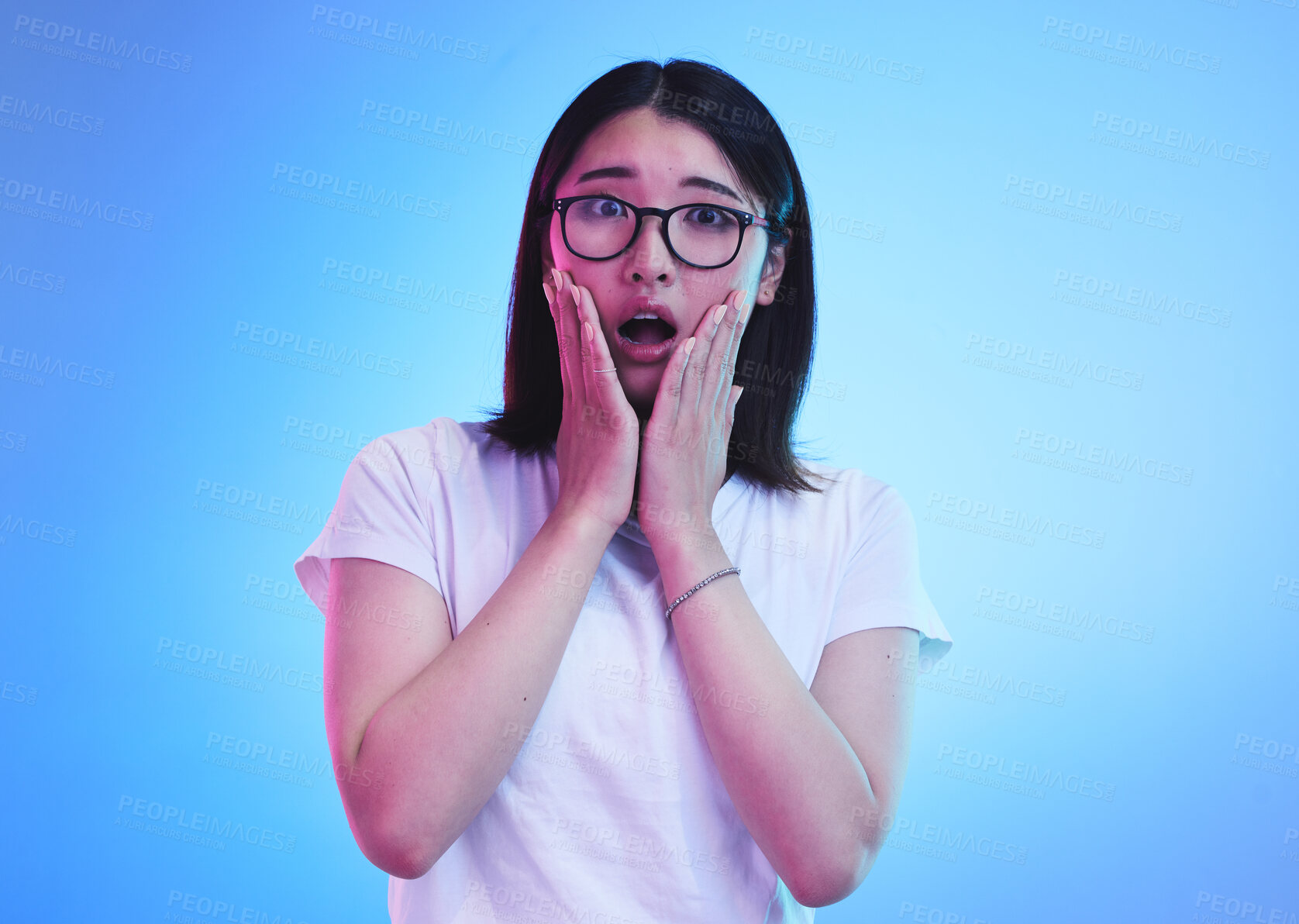 Buy stock photo Surprise, open mouth and face of Asian woman with wow expression or shocked for drama, deal and promotion. Omg, wtf and portrait of person with discount emoji isolated in a studio blue background