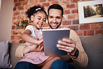Dad, child and tablet for learning on sofa in family home or reading online, playing a game or technology for education. Father, kid and mobile app to teach or streaming cartoon and relax watching tv
