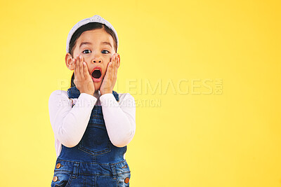 Buy stock photo Fashion, wow and hands on face of girl child in studio surprise, omg or wtf for promo, deal or giveaway on yellow background. Portrait, emoji and kid with open mouth for news, info or clothes sale