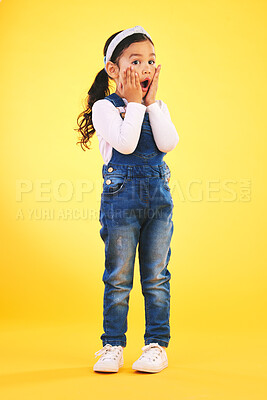 Buy stock photo Children, fashion and hands on face of girl child in studio with deal, sale or giveaway promo on yellow background. Wow, surprise and open mouth kid with emoji for news, announcement or sign up info