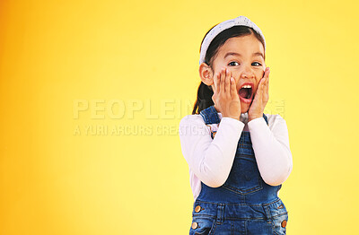 Buy stock photo Fashion, surprise and hands on face of girl child in studio wow, omg or wtf for promo, deal or giveaway on yellow background. Portrait, emoji and kid with open mouth for news, info or clothes sale