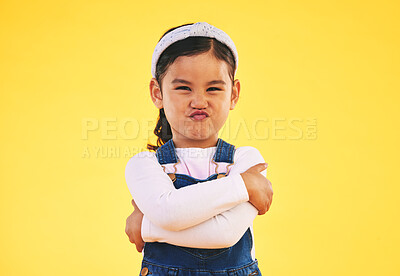 Buy stock photo Portrait, arms crossed and angry girl child in studio with bad, attitude or behavior problem on yellow background. Frown, face and asian kid with body language for no, frustrated or tantrum emoji