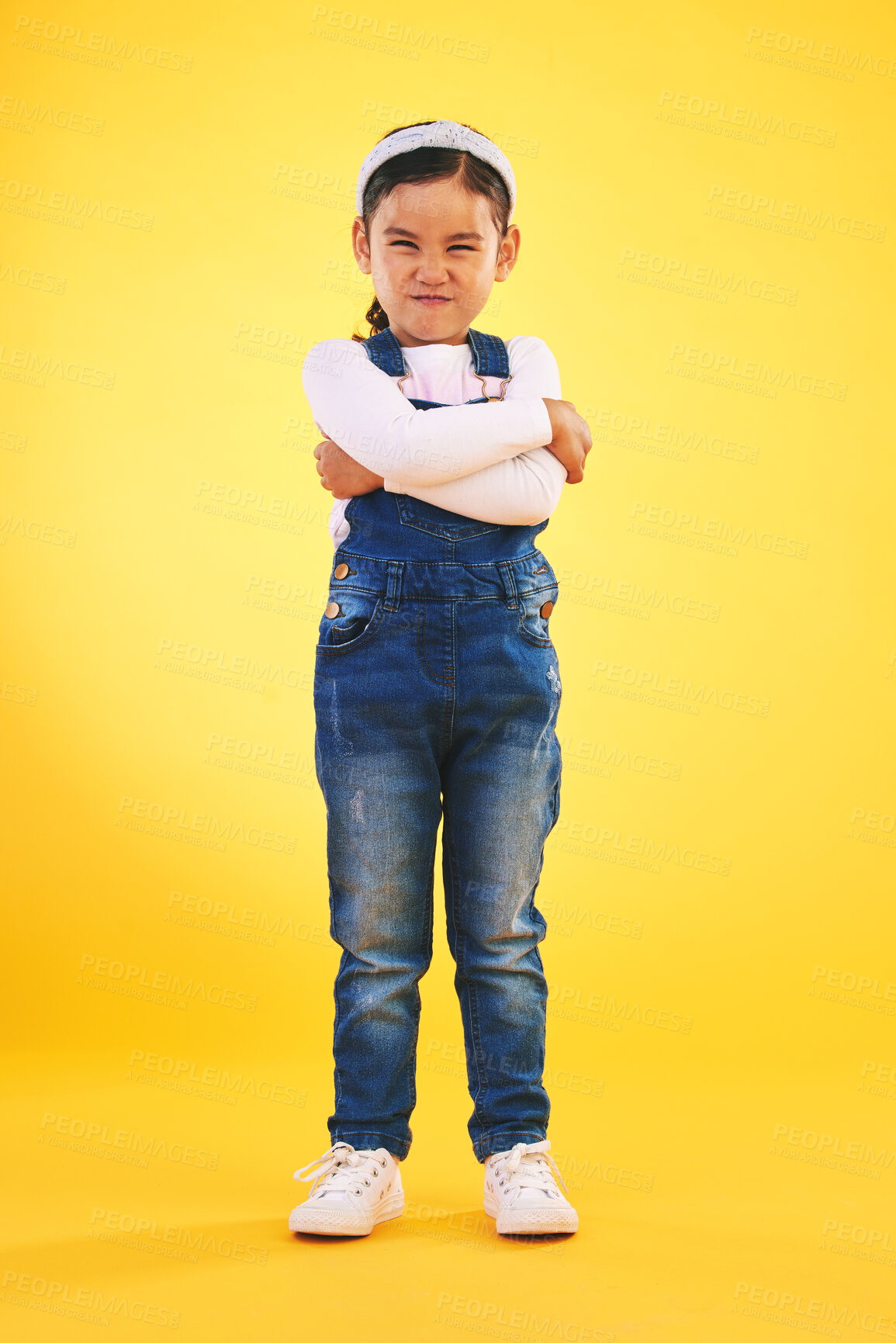 Buy stock photo Arms crossed, angry and portrait of girl child in studio with bad, attitude or behavior problem on yellow background. Frown, face and asian kid with body language for no, frustrated or tantrum emoji
