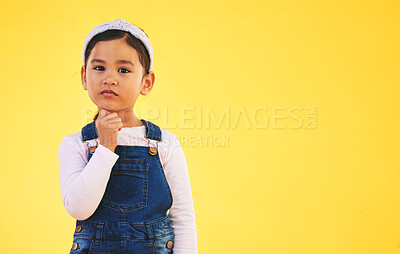 Buy stock photo Girl child, studio portrait and space for thinking, promotion or mockup by yellow background. Young female kid, fashion and trendy clothes with hand by face for idea, style or confused with memory