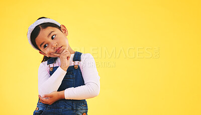 Buy stock photo Confused, thinking and kid in doubt, decision and studio isolated on yellow background mockup space. Question, idea and girl child trying to remember memory, solution or choice, why and brainstorming