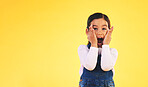 Portrait, fashion and hands on face of girl child in studio with deal, sale or giveaway promo on yellow background. Excited, surprise and open mouth kid with emoji for news, announcement or wow info