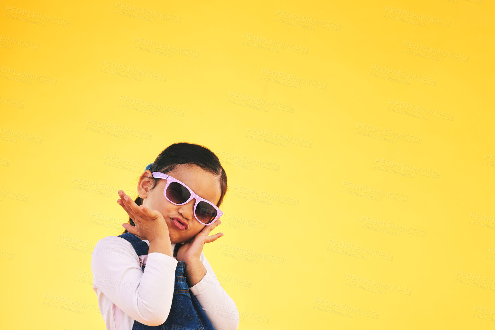 Buy stock photo Girl, child and portrait with sunglasses in studio for confidence, cool and fun attitude. Face, space and young kid with mockup, pose and fashion announcement isolated on a yellow background