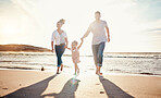 Family, beach and holding hands, parents and kid with travel and bonding, love and walking together in nature. Vacation, ocean and happy people outdoor, parents and child with sun and adventure 