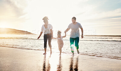 Buy stock photo Playing, beach and family walking together on a vacation, adventure or holiday together for bonding. Sunset, having fun and girl child with her mother and father on the sand by ocean on weekend trip.
