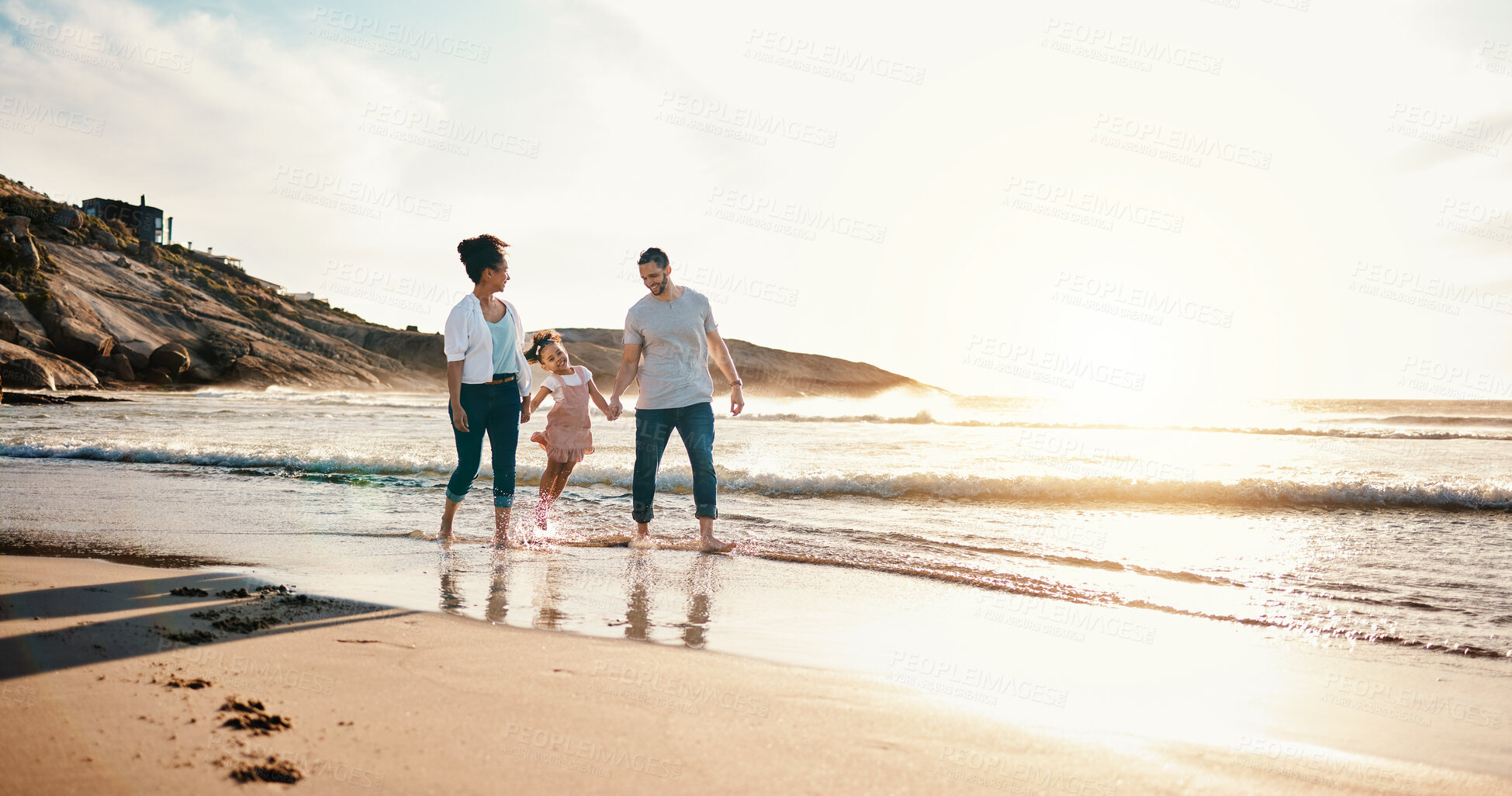 Buy stock photo Walking, bonding and family on the beach for vacation, adventure or holiday together at sunset. Travel, having fun and girl child with her mother and father on the sand by the ocean on weekend trip.