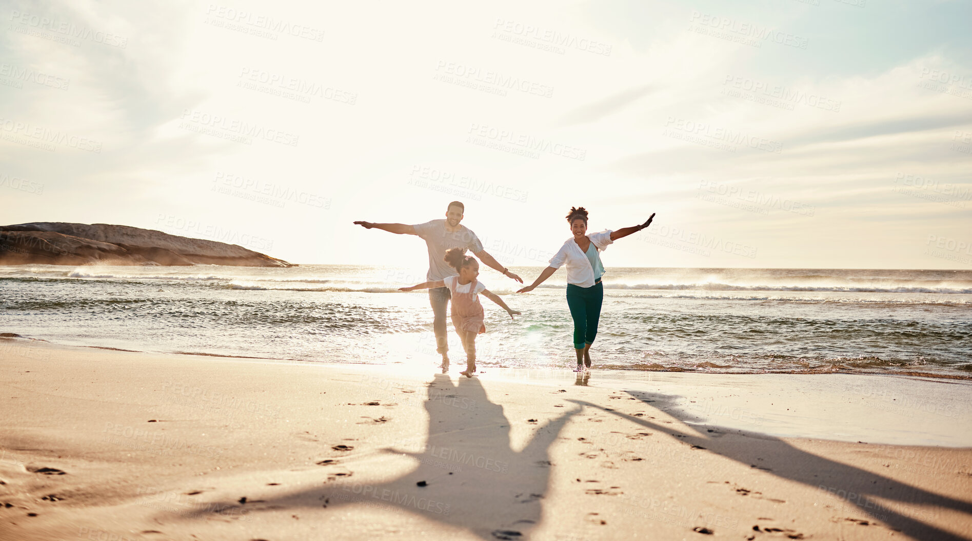 Buy stock photo Family, running and freedom on beach with sunshine, happiness and fun together, games and bonding on vacation. Travel, adventure and playful, parents and child, happy people in nature with energy