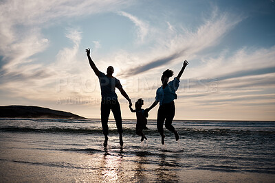 Buy stock photo Family, jump and freedom on beach with silhouette, fun together outdoor with games and bonding on vacation. Travel, adventure and playful, parents and child with happy people in air and energy