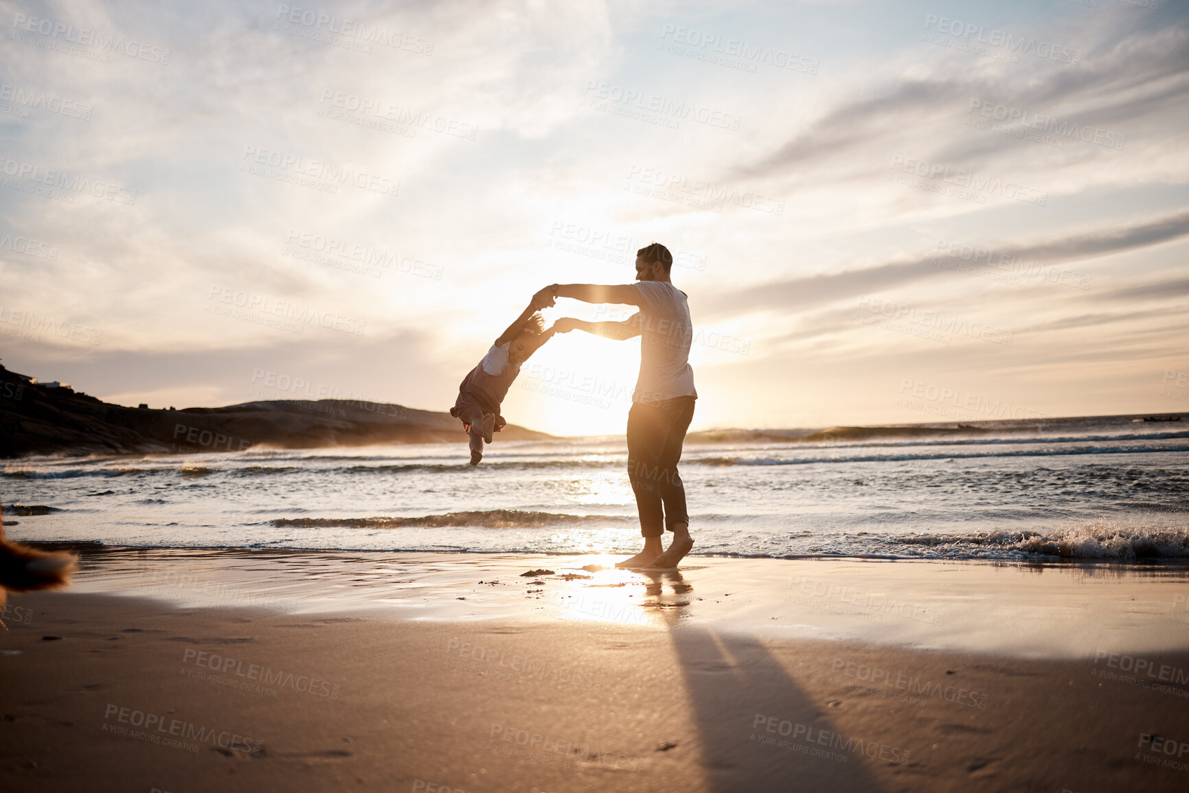 Buy stock photo Swing, love and father with girl child at a beach holding hands in nature for play, freedom or bond at sunset. Ocean, travel and parent with kid at sea for spinning fun, games or celebration in Bali