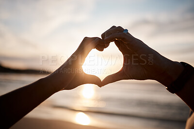 Buy stock photo Couple, heart and hands at beach in sunset for love, care and relax on holiday, vacation and travel. Closeup of people, silhouette and finger shape at sea for support, freedom and emoji sign in sky 