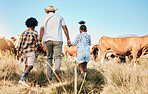 Farm, cows and father holding hands with children in countryside for ecology, adventure and vacation. Family, sustainable farming and back of dad with kids for bonding, relax and learning with animal