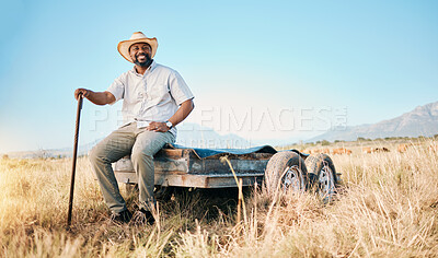 Buy stock photo Portrait, African farmer and land in the countryside and man, sitting and watching over agriculture, field and environment. Farming, meadow and happy worker outdoor with happiness or smile in summer