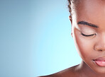 Beauty, half face mockup and black woman relax with self care wellness, eyeliner cosmetics or eyebrow treatment. Advertising makeup, studio space or African person with eyes closed on blue background