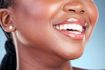 Happy woman, teeth and smile in dental cleaning, hygiene or treatment against a blue studio background. Closeup of female person mouth in tooth whitening, oral or gum healthcare for healthy wellness