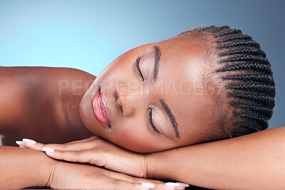 Buy stock photo Skincare, relax and black woman in studio, sleeping and natural makeup with dermatology at luxury spa. Cosmetics, rest and dream facial beauty treatment with self care on blue background in Africa.