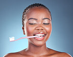 Happy black woman, toothbrush and teeth in dental cleaning or care against a studio background. Face of African female person smile in morning routine tooth whitening, oral or mouth and gum hygiene