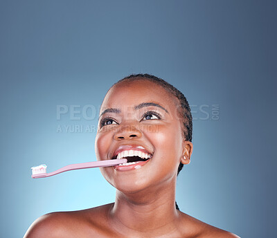 Buy stock photo Black woman, face or toothbrush for cleaning teeth on isolated blue background, studio or mockup space. Smile, model or dental toothpaste for gum wellness, breath or mouth hygiene in grooming routine