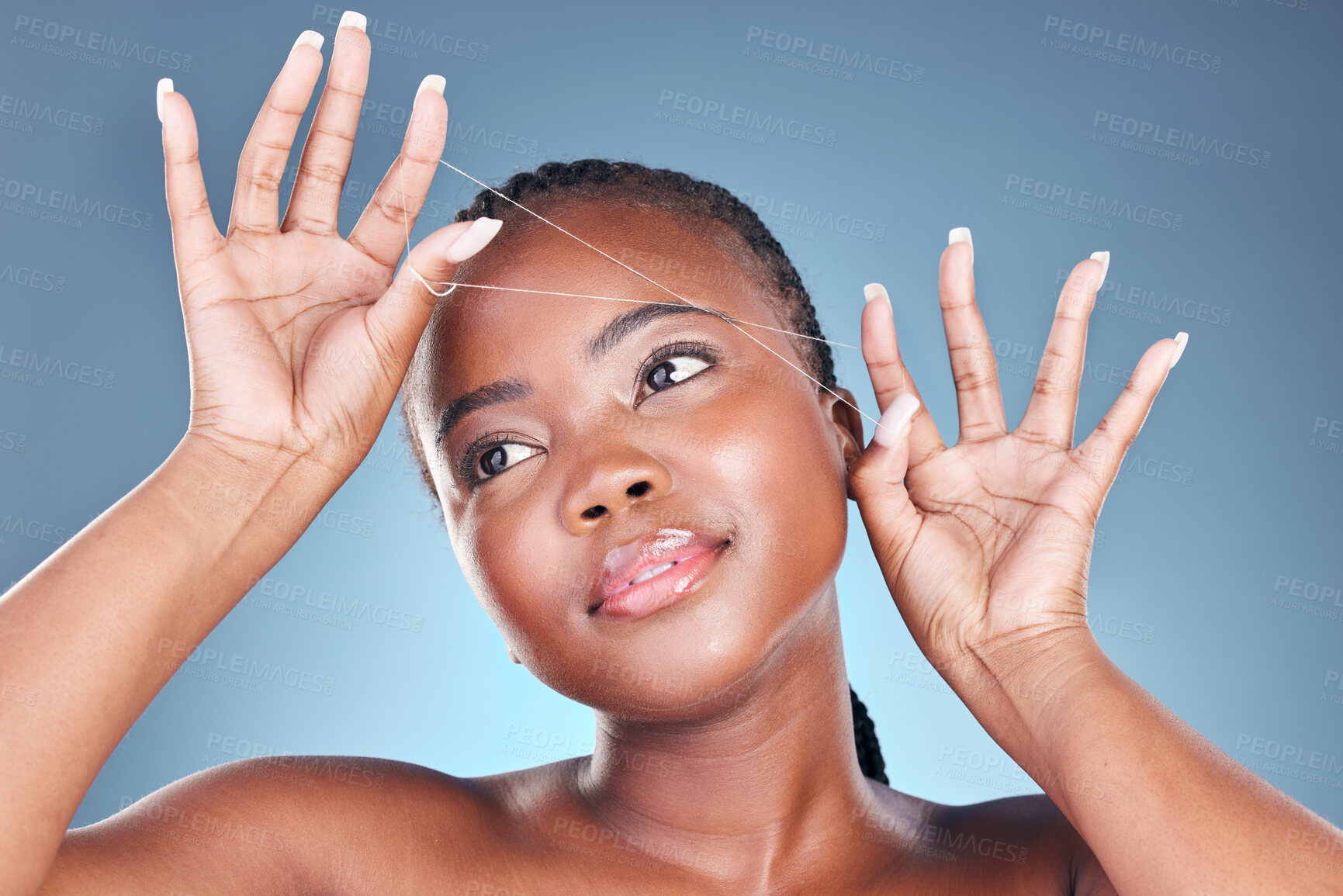Buy stock photo Eyebrow pluck, thread and beauty of a woman with dermatology, natural makeup and skincare. Face of an African person on a studio background with cosmetics, hair removal and facial glow or self care