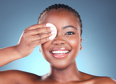 Buy stock photo Black woman, portrait smile and cotton pad for makeup removal against a blue studio background. Face of happy African female person with swab in beauty for cleaning, hygiene or facial treatment