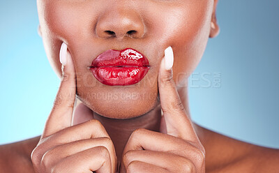 Buy stock photo Woman, kiss and red lipstick, beauty and makeup closeup with hands on face isolated on blue background. Model, bold and  cosmetic product on lips, lipgloss and mouth with skin and shine in studio