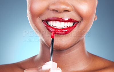 Buy stock photo Woman, smile and red lipstick with brush and beauty, happy with makeup closeup isolated on blue background. Model, bold and cosmetic product on lips, mouth with skin and teeth with shine in studio