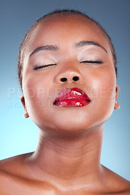 Buy stock photo Dermatology, beauty and black woman with makeup, cosmetics and gloss on a blue studio background. Luxury, African person or model with wellness, spa facial and glow with aesthetic, shine and skincare