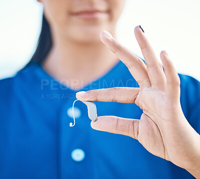 Buy stock photo Sports, hands and a deaf person with a hearing aid for communication, baseball support or listening. Closeup, fingers and an athlete or person with a medical implant during training or fitness
