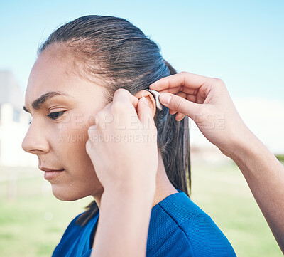 Buy stock photo Hands, profile and woman in hearing aid, ear and sound amplifier at park outdoor. Help, person with a disability and deaf tools in audio communication, wear technology and listening on microphone