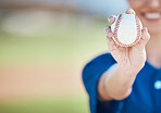 Hand, ball and softball with a woman on mockup for sports competition or fitness outdoor during summer. Exercise, training and baseball with a sporty female athlete on a pitch for playing a game