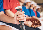 Hand, softball and bat with sports and team, fitness and mission with closeup, people in dugout watching game. Athlete group, exercise and support with collaboration and baseball player in club