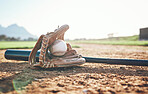 Glove, bat and baseball gear on a field for a game, professional competition or sports. Ground, fitness and equipment for a match, fitness or training for softball on the sand in summer for cardio