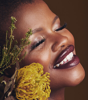 Buy stock photo Face, beauty and protea with the smile of a black woman in studio on brown background for natural treatment. Happy, plant or cosmetics and a young model indoor for aesthetic wellness with flowers