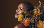 Thinking, flowers and black woman with skincare, dermatology and cosmetics on a brown studio background. Ideas, person and model with natural beauty, mockup space and wellness with plants and shine