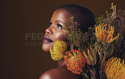 Buy stock photo Thinking, flowers and black woman with skincare, dermatology and cosmetics on a brown studio background. Ideas, person and model with natural beauty, mockup space and wellness with plants and shine