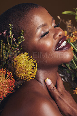 Buy stock photo Skincare, beauty and protea flower with a black woman in studio on brown background for natural treatment. Face, plant or cosmetics and a young model indoor for aesthetic wellness with a smile