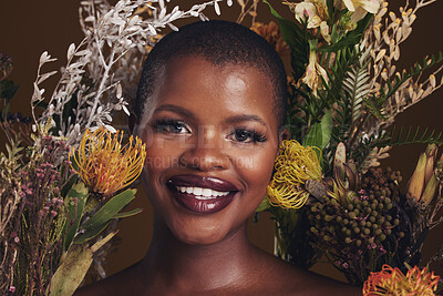 Buy stock photo African woman, flowers and makeup in studio portrait with beauty, wellness or natural glow by brown background. Girl, model and face with leaves, plants and happy for cosmetics, skincare or aesthetic