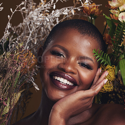 Buy stock photo African woman, plants and makeup in studio portrait with beauty, wellness and natural glow by brown background. Girl, model and face with leaves, flowers and happy for cosmetics, shine or aesthetic