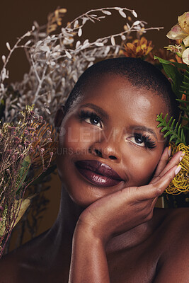 Buy stock photo African woman, plants and thinking in studio with flowers for beauty, wellness or natural glow by brown background. Girl, model and face with leaves, ideas and memory for cosmetics, skin or aesthetic