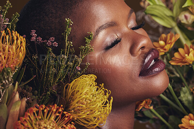 Buy stock photo Black woman, flowers and beauty with face, makeup and natural cosmetic care isolated on studio background. African model, plants and nature with sustainable skincare, eyes closed with facial and glow