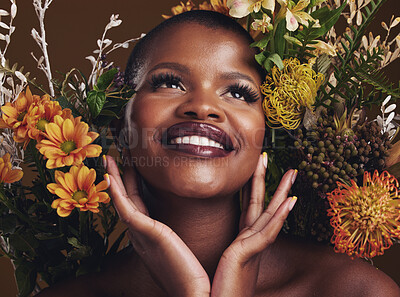 Buy stock photo African woman, plants and ideas in studio with flowers for beauty, wellness or smile for glow by brown background. Girl, model and face for thinking, leaves or memory for cosmetics, skin or aesthetic