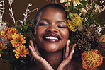 Skincare, cosmetics and protea with the face of a black woman in studio on brown background for natural treatment. Smile, plant or beauty and a happy model indoor for aesthetic wellness with flowers