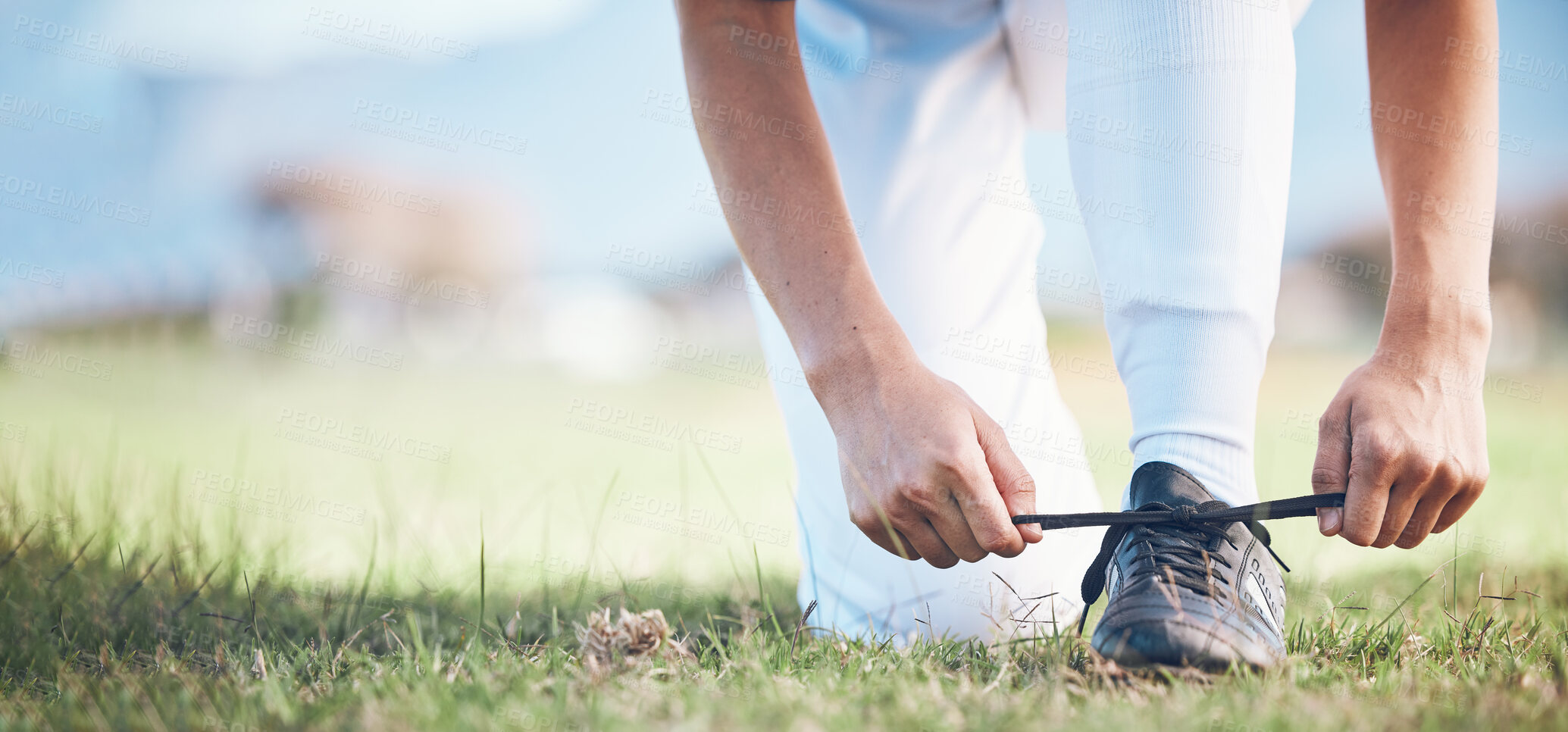 Buy stock photo Hands, feet and a sports person tying laces on a baseball field outdoor with mockup space for fitness. Exercise, shoes and getting ready with an athlete on a pitch for a match or training closeup